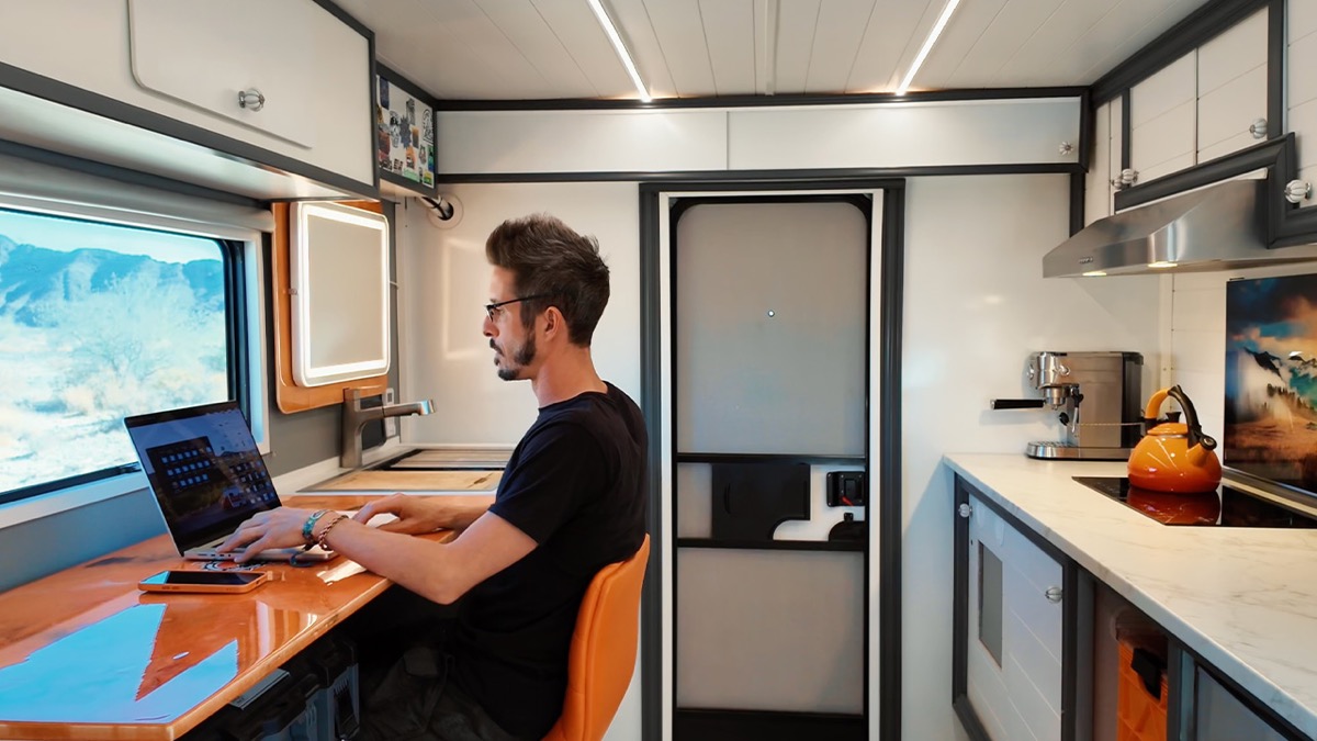 Nomad Brad working on laptop inside the solar-powered box truck